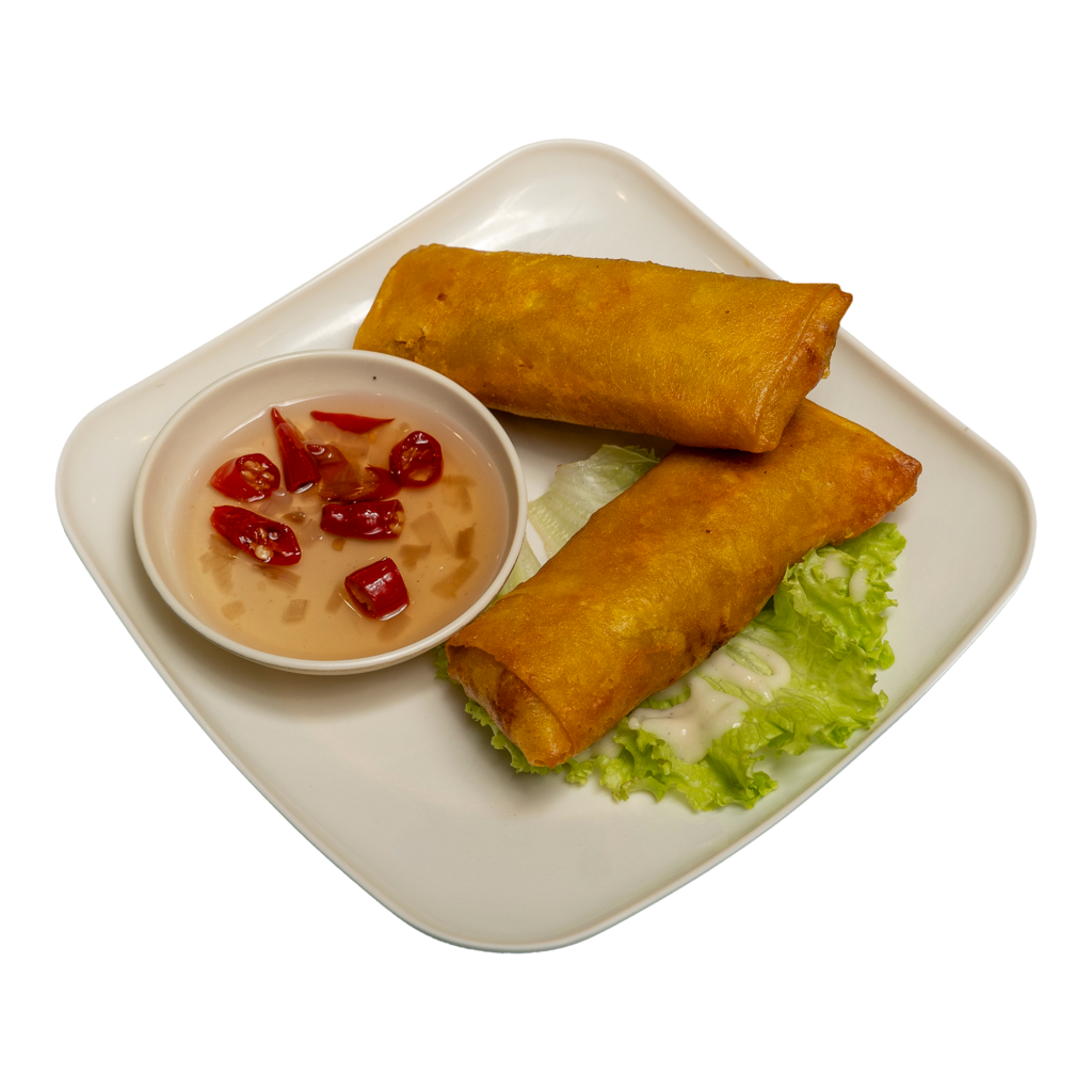 Two pieces of vegetable lumpia with dip on a white plate.